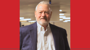 portrait of a businessman wearing a dark jacket and white button down shirt